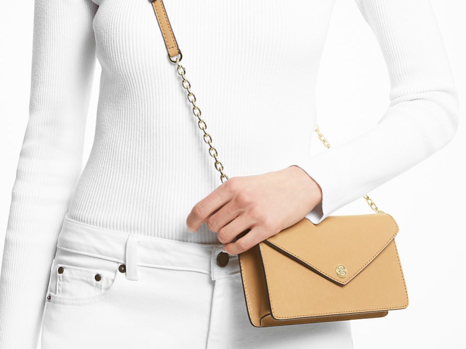woman in white outfit with tan crossbody bag