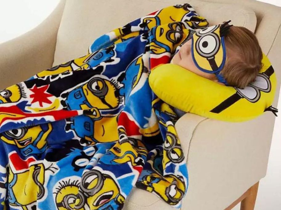 Child laying on a chair using a Minions 3-piece Travel Set