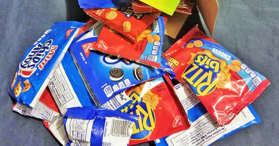 pile of OREO Mini, CHIPS AHOY Mini, Nutter Butter Bites, and RITZ Bits snack bags