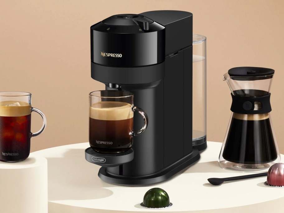 black nespresso machine brewing a cup of coffee