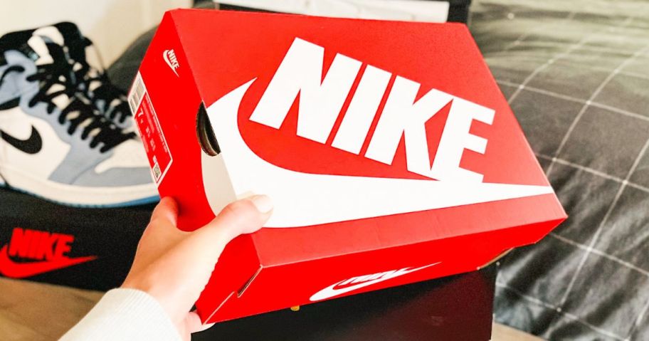 Hand holding a Nike Shoe Box