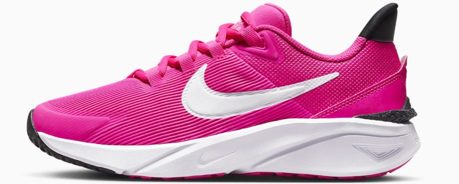 pink and white nike running shoe