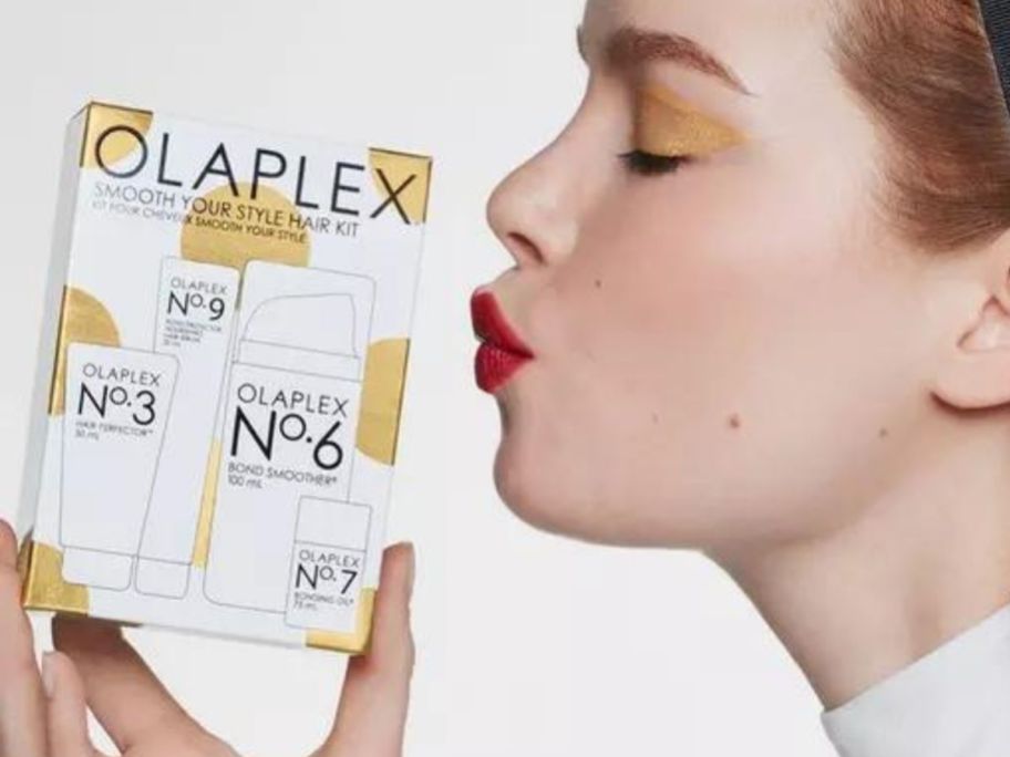Woman about to kiss an Olaplex Hair Kit