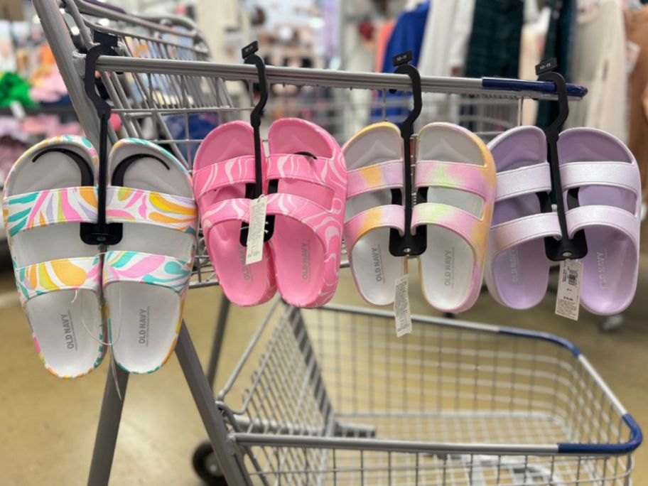 4 pairs of Old Navy Girls Double Strap Sandals hanging on a shopping cart