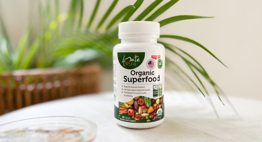 Organic superfood pills displayed on the table with palm trees in the background