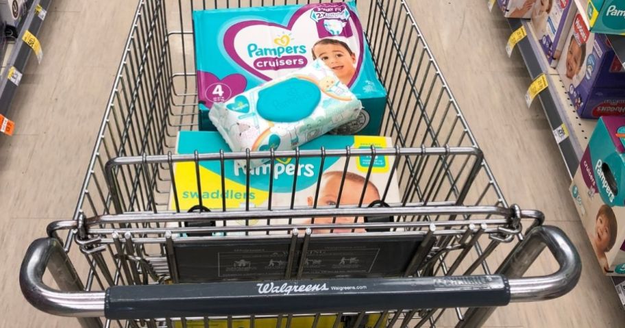 A walgreens cart with two boxes of diapers and a pack of baby wipes
