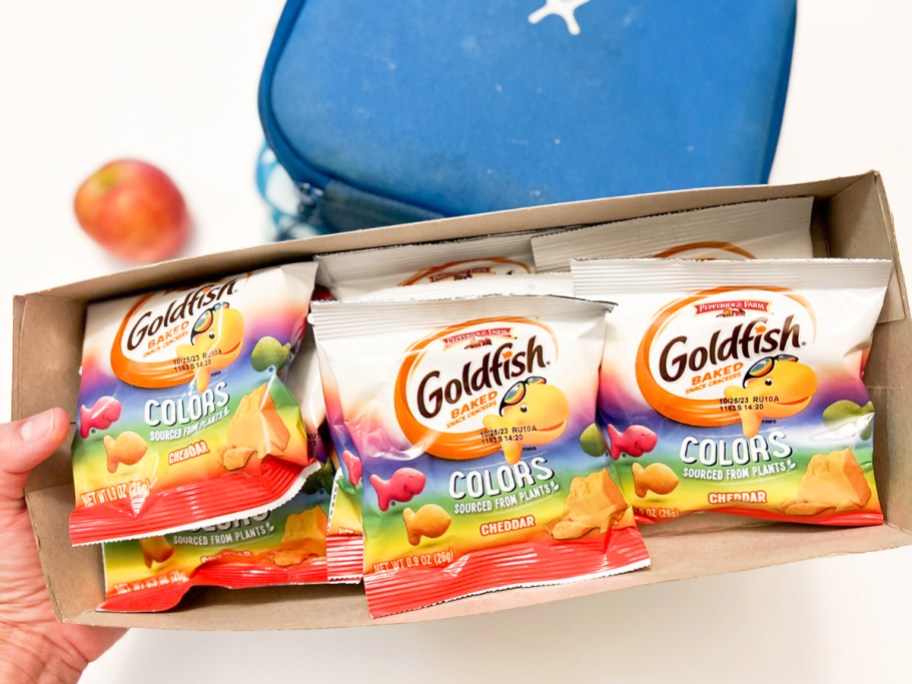 hand holding box of individual bags of goldfish colors crackers