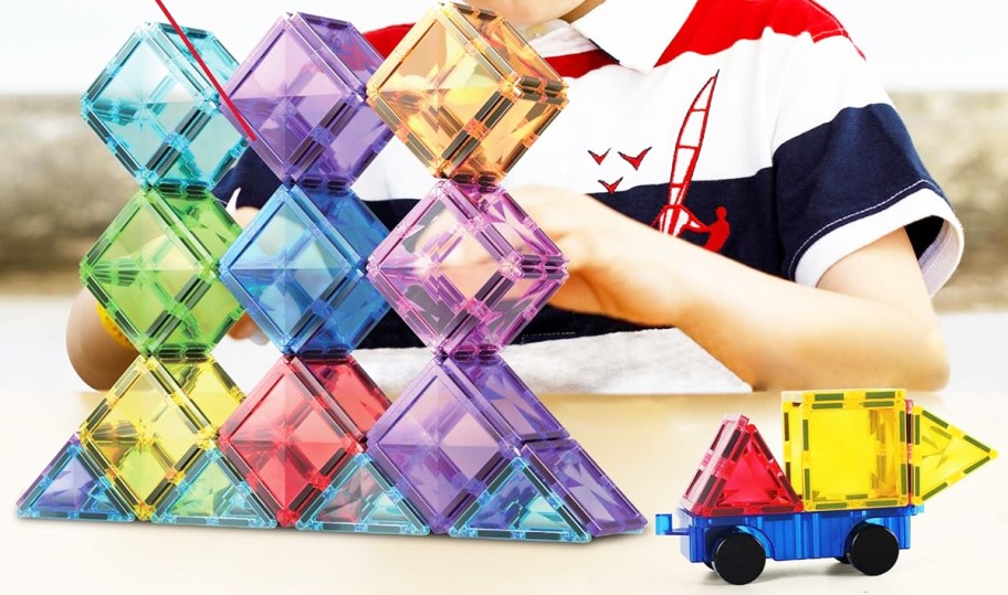 boy playing with PicassoTiles set on table