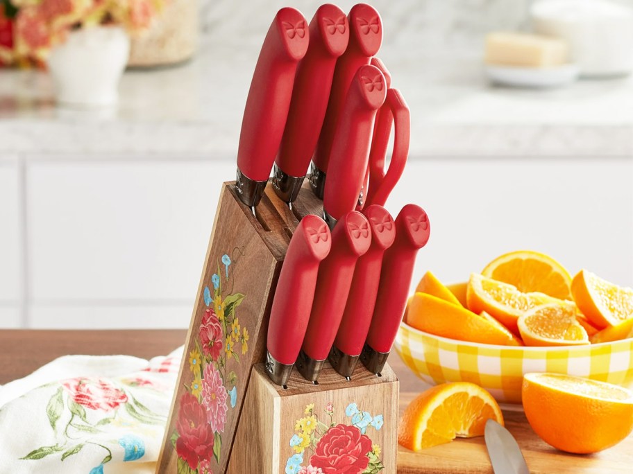 set of red kitchen knives in a floral print wood block