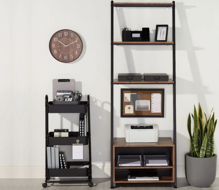 A Realspace Belling Bookcase next to a rolling storage cart