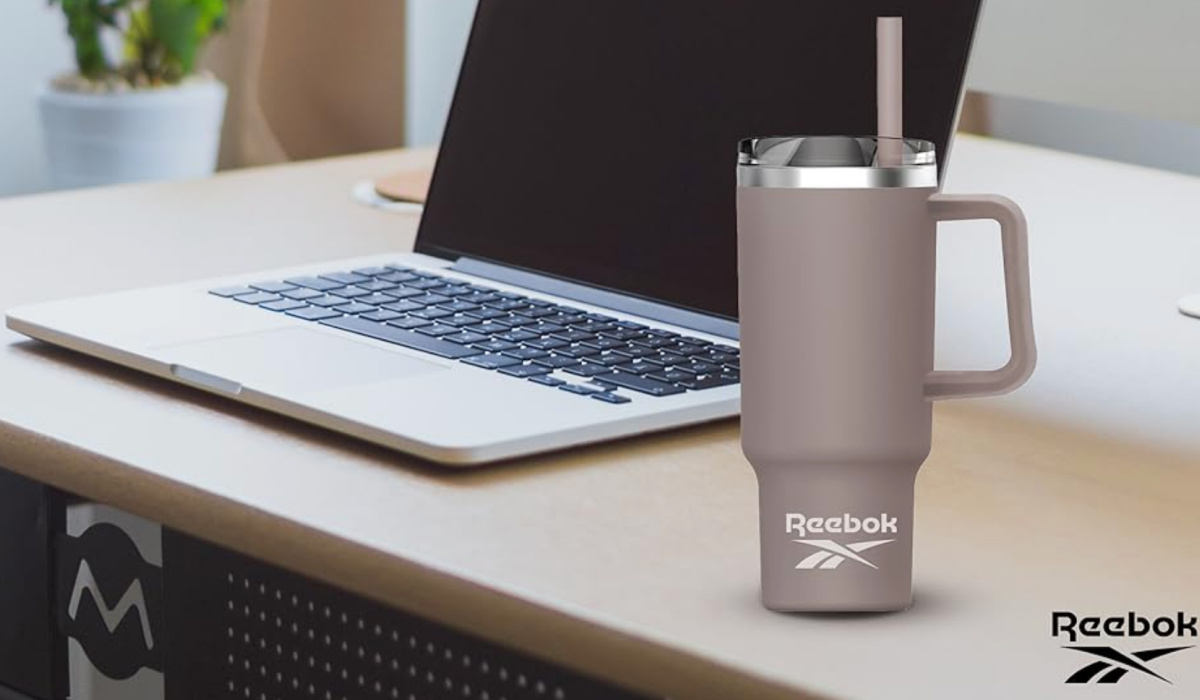 Reebok Gray Tumbler next to laptop on desk