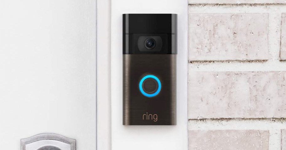 brown and black Ring Video Doorbell mounted next to front door