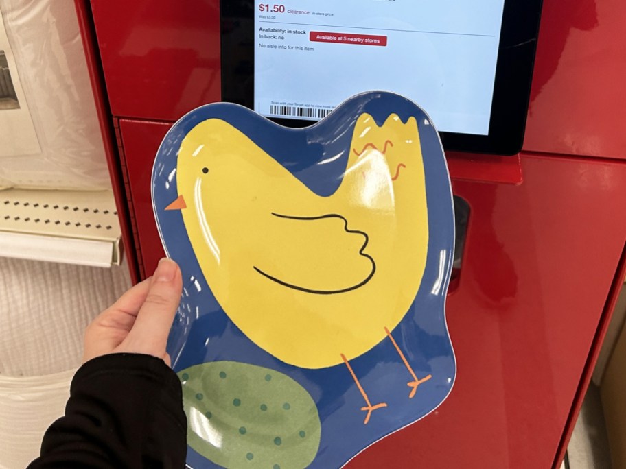 holding an easter chick shaped plate up to a price scanner