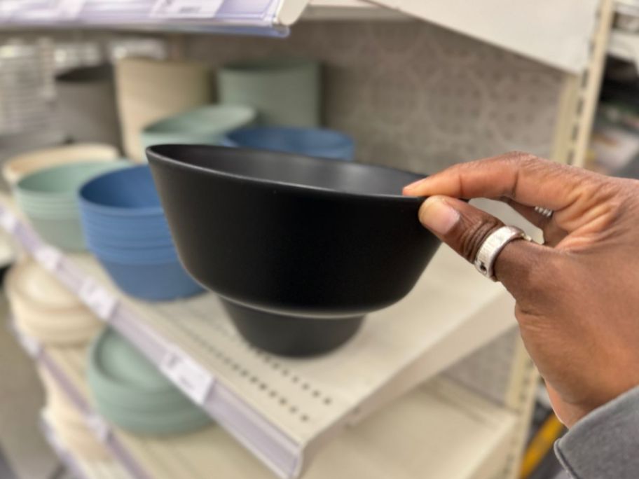 A hand holding a Room Essentials Bowls in black 