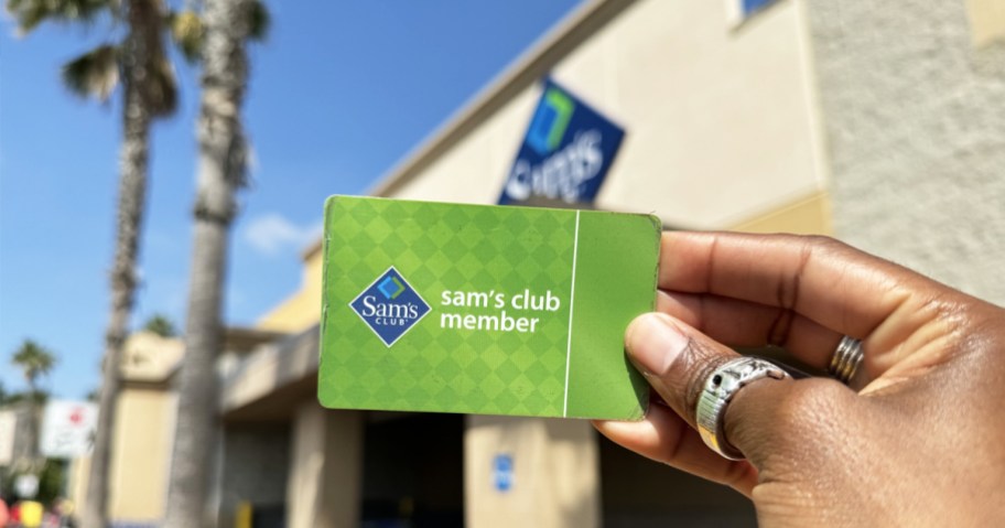 holding a sam's club membership card outside of store
