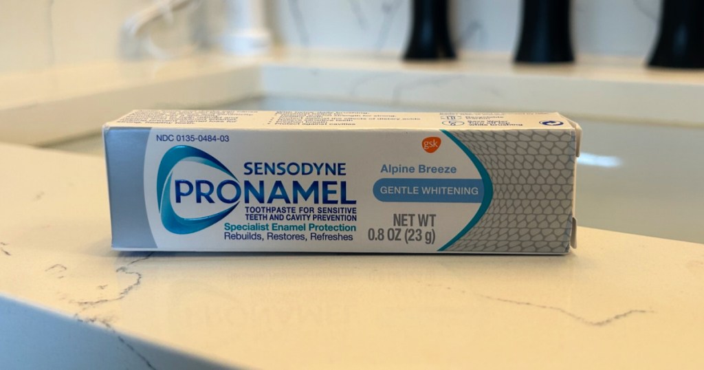 Travel size box of Sensodyne ProNamel toothpaste on bathroom counter