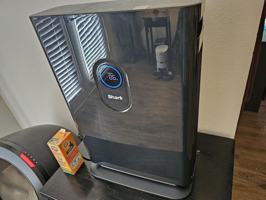 a shark air purifier in a room on top of a side table