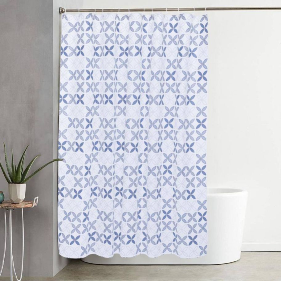 a blue and white leaf patterned shower curtain