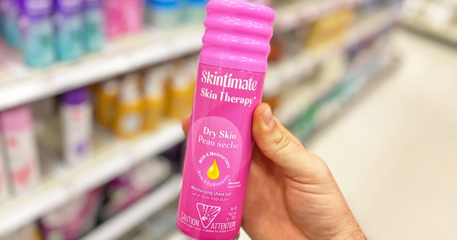 hand holding a pink can of Skintimate Shave Gel in store