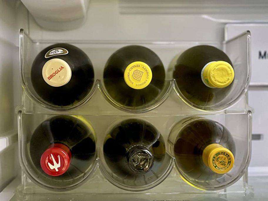 Stackable water bottle holder being used in the fridge to store wine