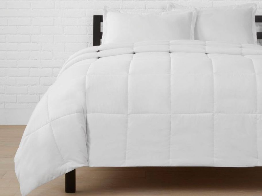 A bed with a white bedspread