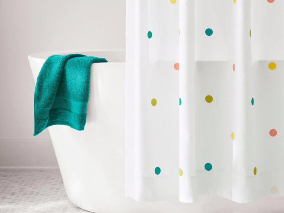 polka dot print shower curtain in front of bathtub