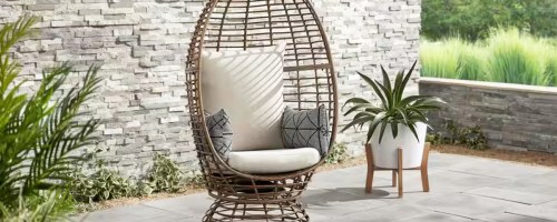 Egg chair with cushions and pillows on a patio