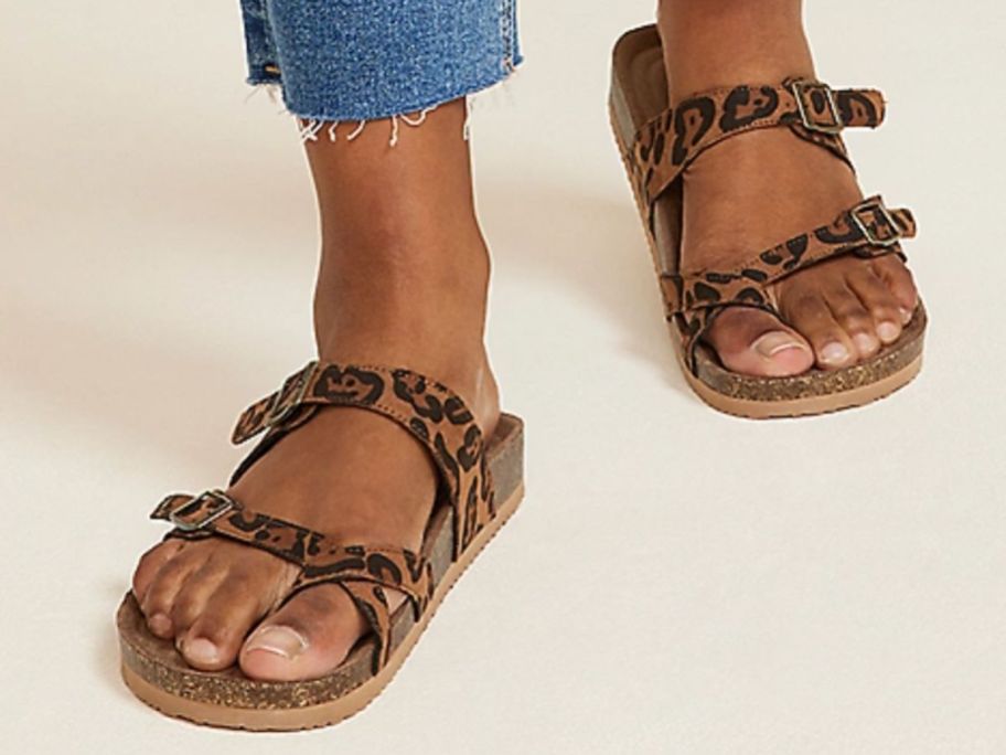 A woman wearing a pair of SuperCush Ashley Strappy Footbed Sandal