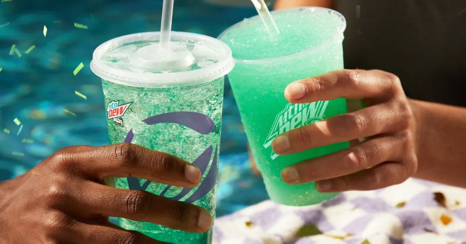 two people holding up a baja blast drink and freeze