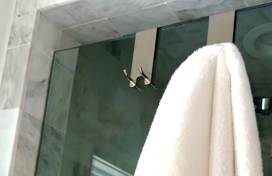 silver towel hooks on glass shower door