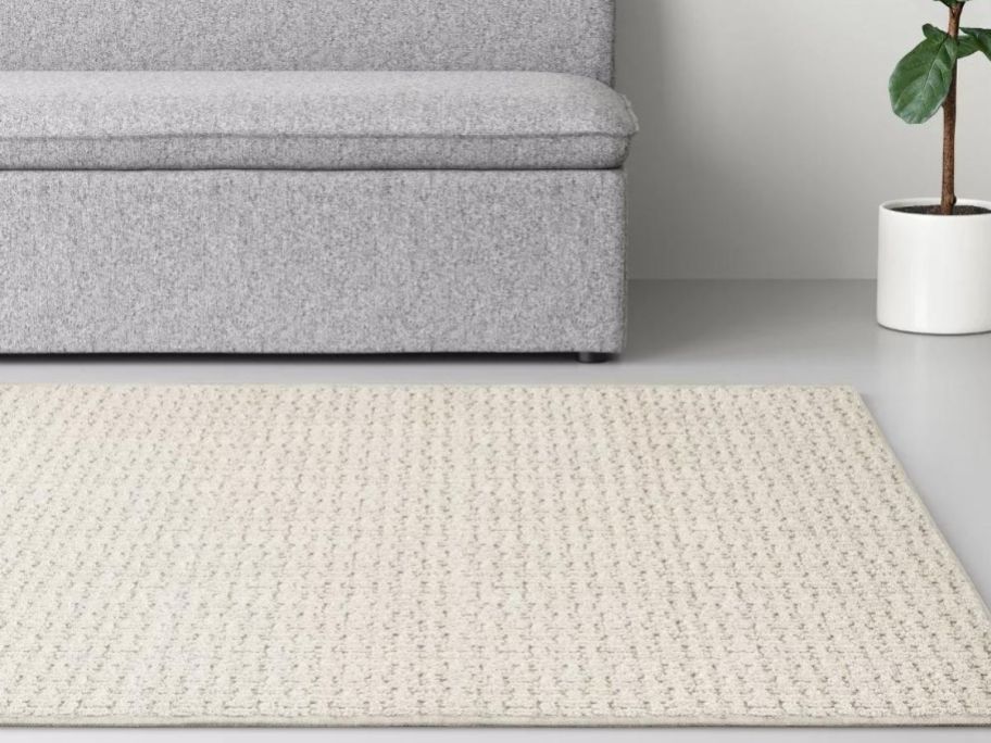A Made by Design Washable rug in front of a sofa