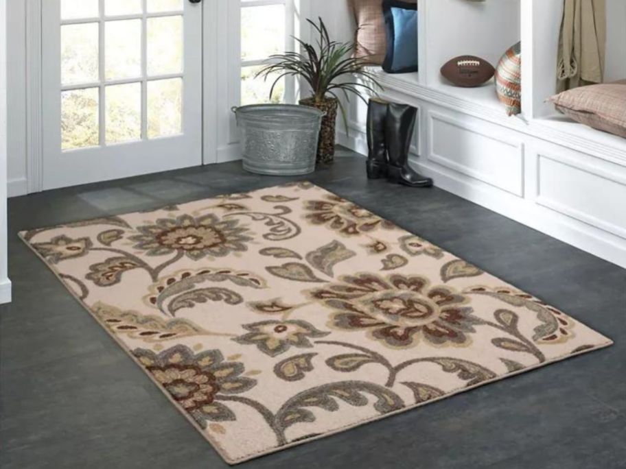 a entryway with a floral Maples rug