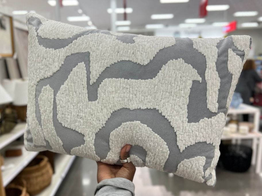 Hand holding a Threshold Throw pillow at Target