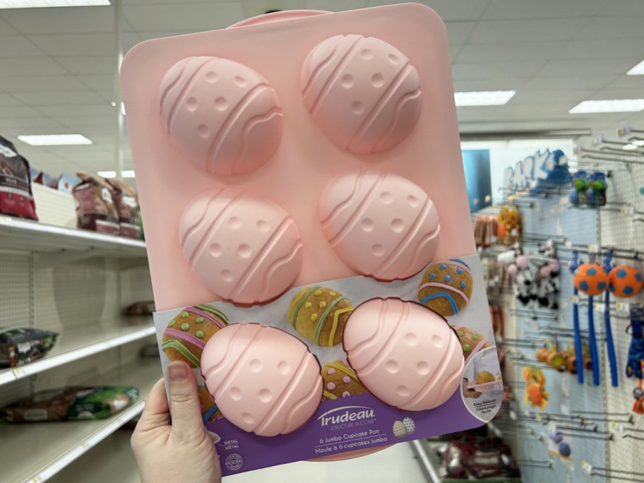 hand holding up pink Trudeau Silicone Jumbo Eggs Pan in store