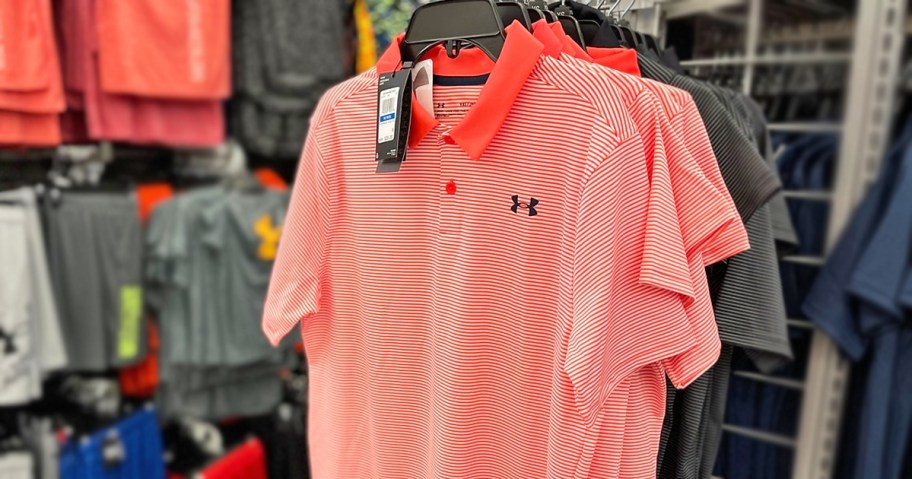 striped under armour polo shirts on hangers in store