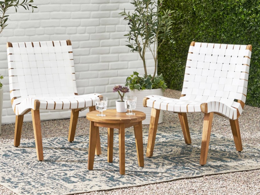 white and wood patio chairs with matching side table