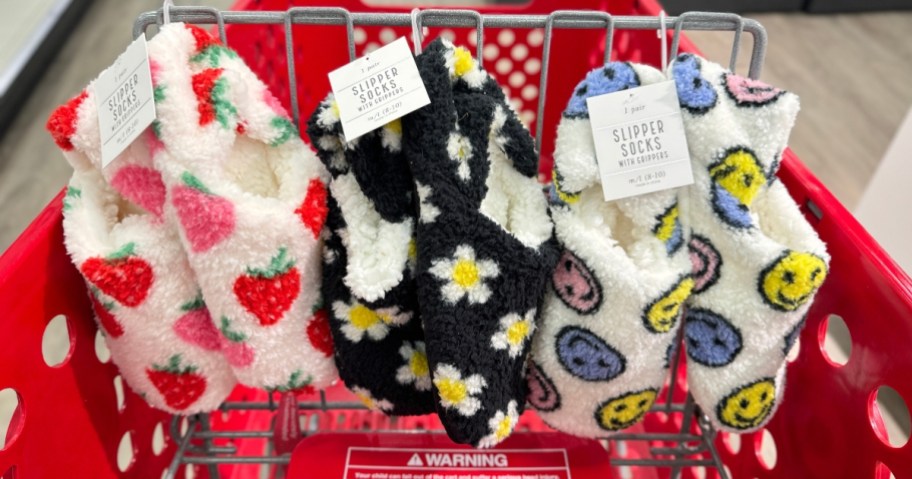 women's fleece slipper socks in various prints in a Target shopping cart