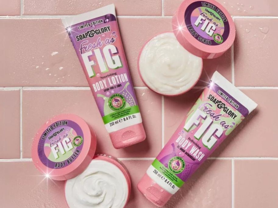 Soap & Glory Fresh as Fig body wash, body lotion and body scrubs laid out on a pink shower tile