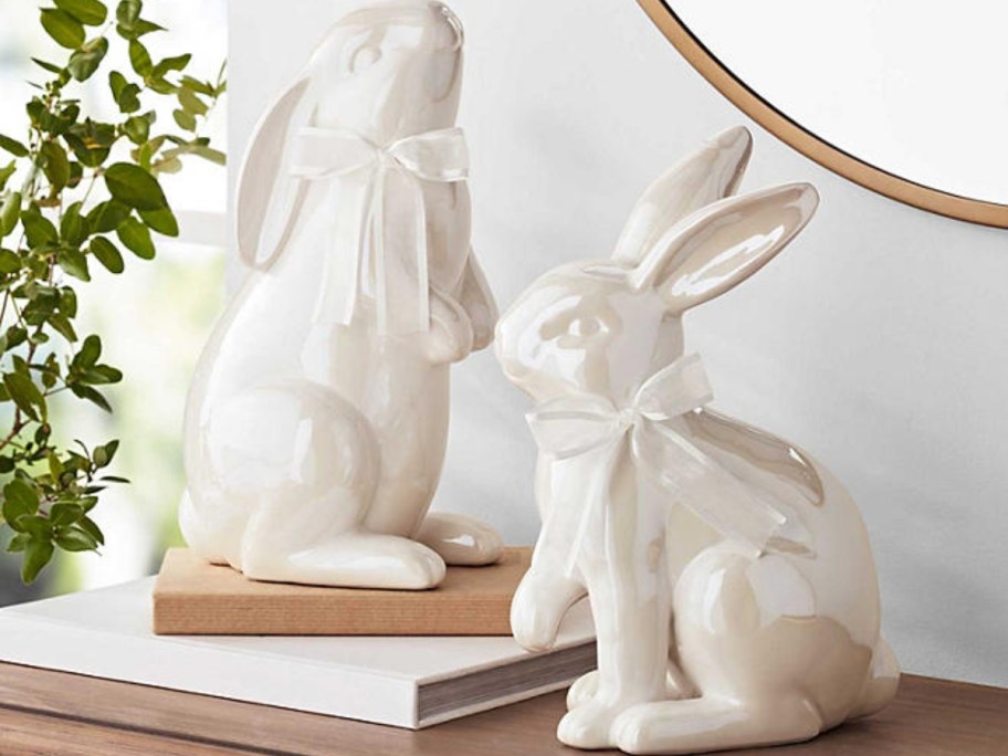 2 white ceramic bunnies on a console table