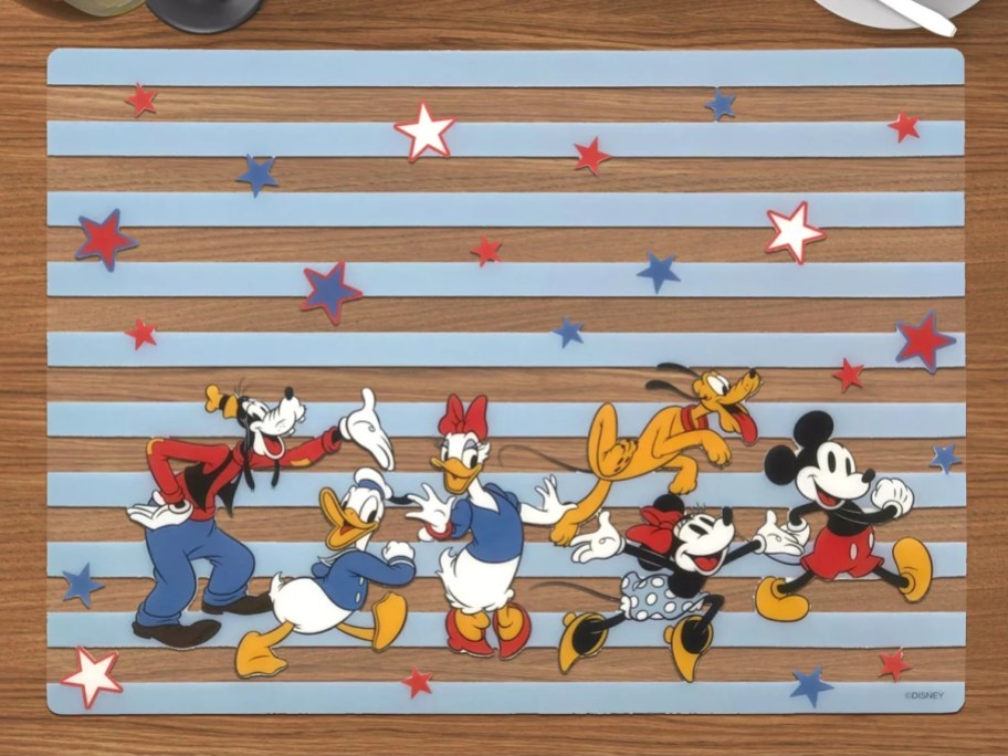 blue and clear stripe plastic placemat with Mickey and Friends and red, white and blue stars