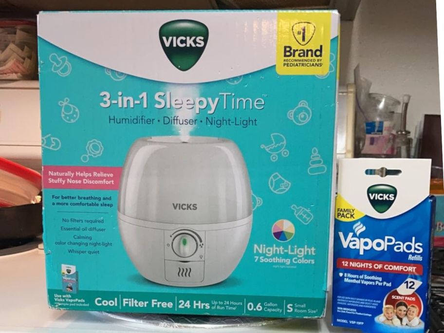 Vicks 3-in-1 Sleepy Time Humidifier and inserts on a stove