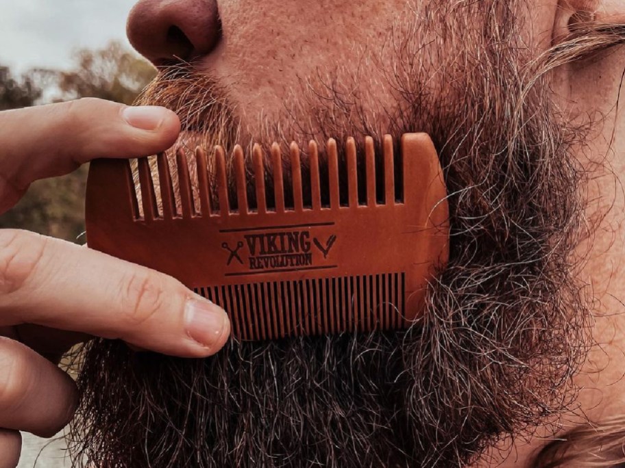 Man using a Viking Revolution comb on his beard