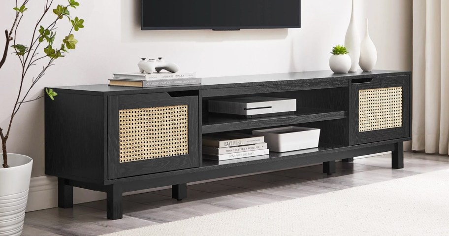 black tv stand with two rattan doors