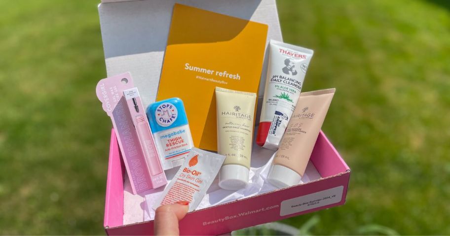 A hand holding a box of beauty products