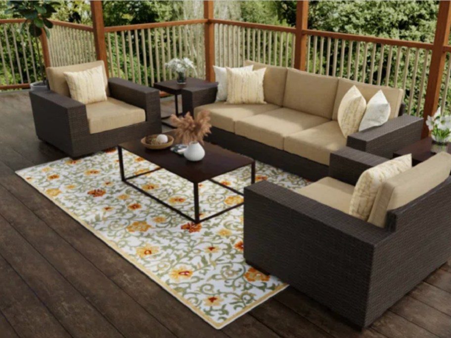 Stock image of a patio with a floral rug from Wayfair