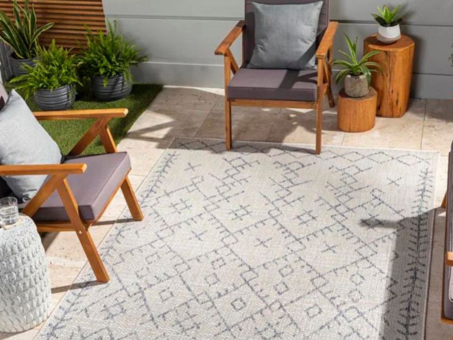 Stock image of a Wayfair outdoor rug on a patio