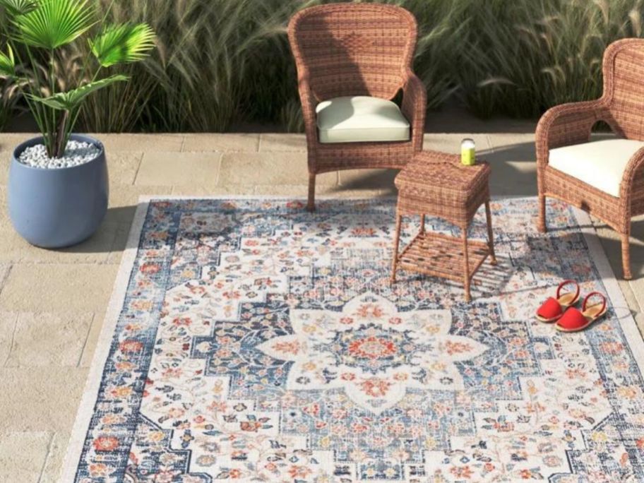 Stock image of a patio with a Wayfair patio rug