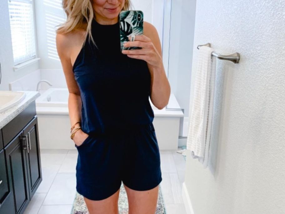 A woman wearing a halter neck romper shorts set in black