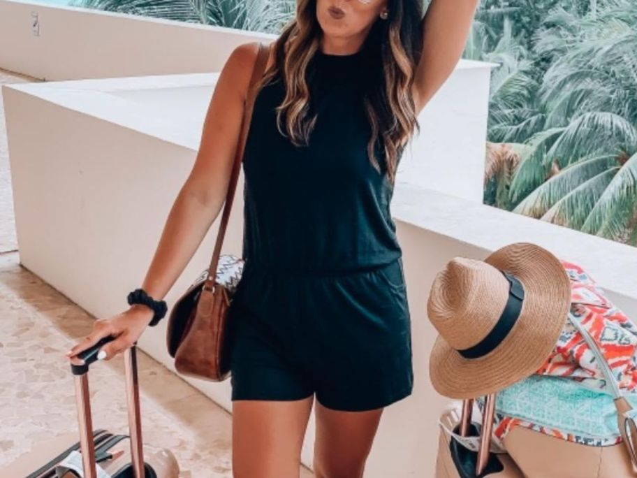 A woman wearing a halter neck romper shorts set in black 