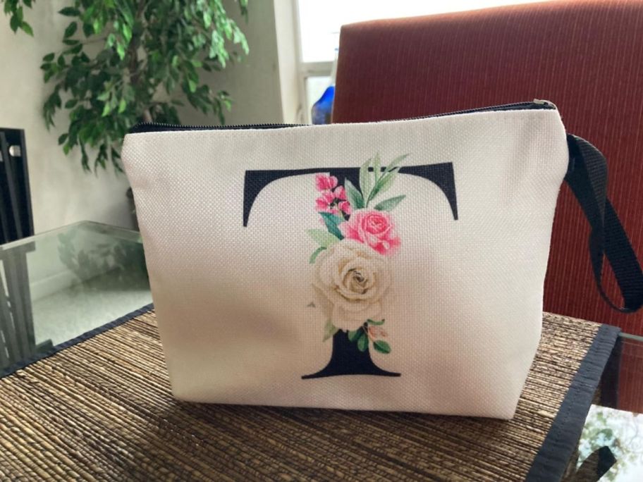 A Cosmetic Bag with an "T" on it 